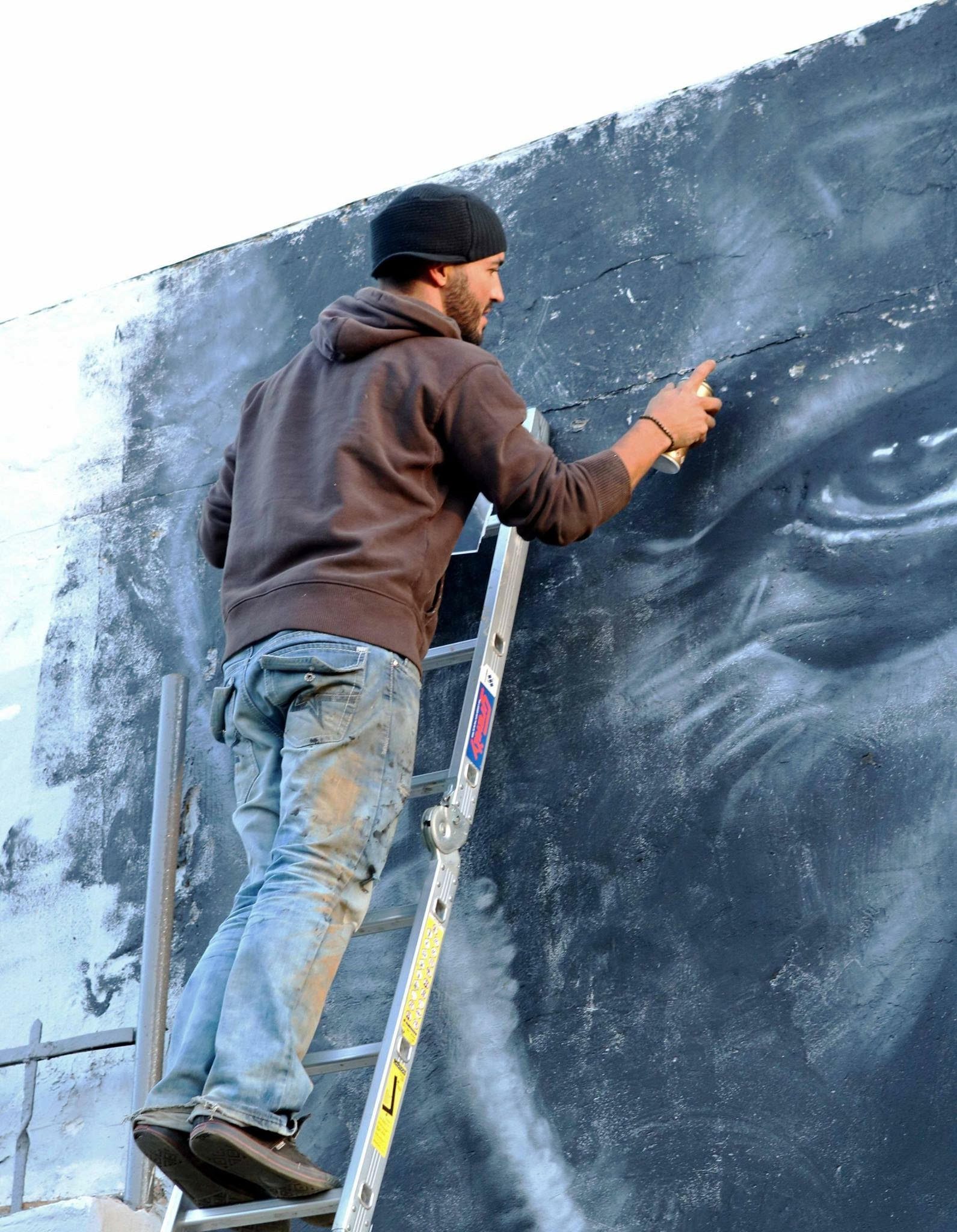 Artist creating a large-scale artwork at Nomad Gallery